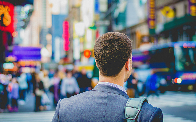 man in big city heading to work