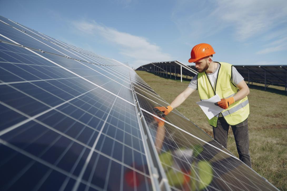 man working on solar panel