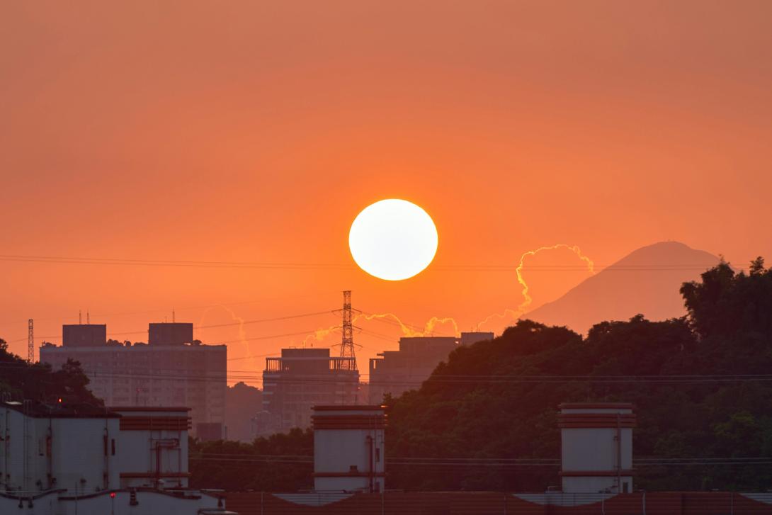 sun setting over a city