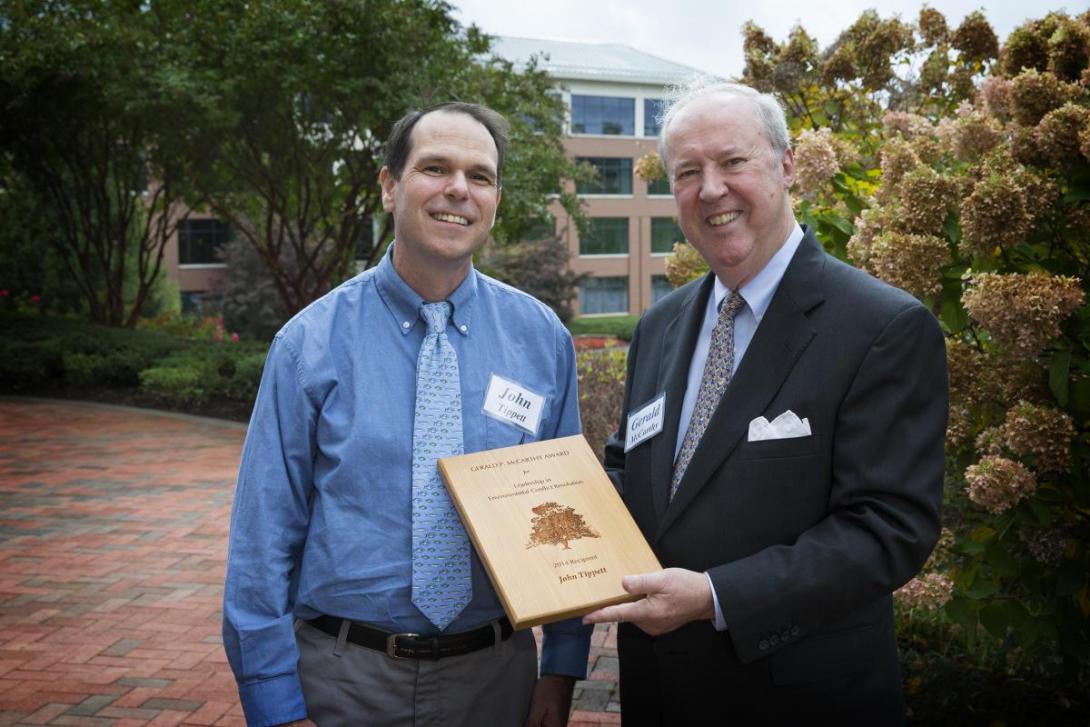 John Tippett receives the McCarthy Award. Gerald McCarthy presents a plaque to John Tippett.
