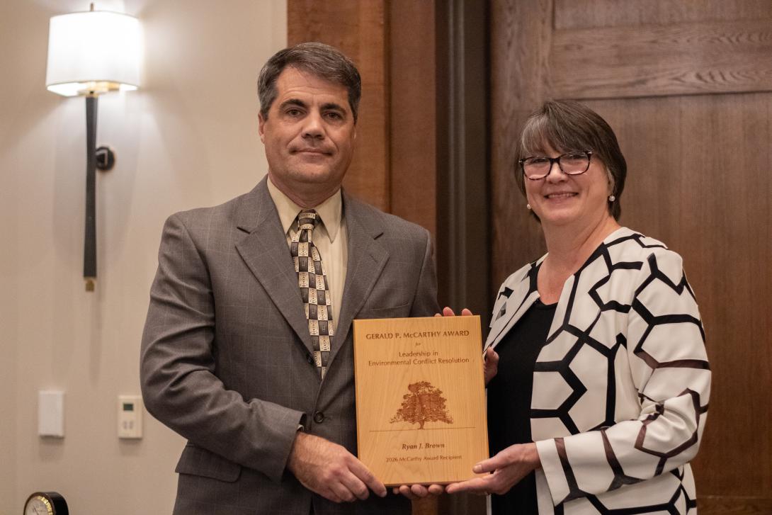 Ryan J. Brown (left) receives award from Bettina Ring (right)
